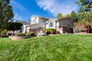 A large house with a lawn in front of it.